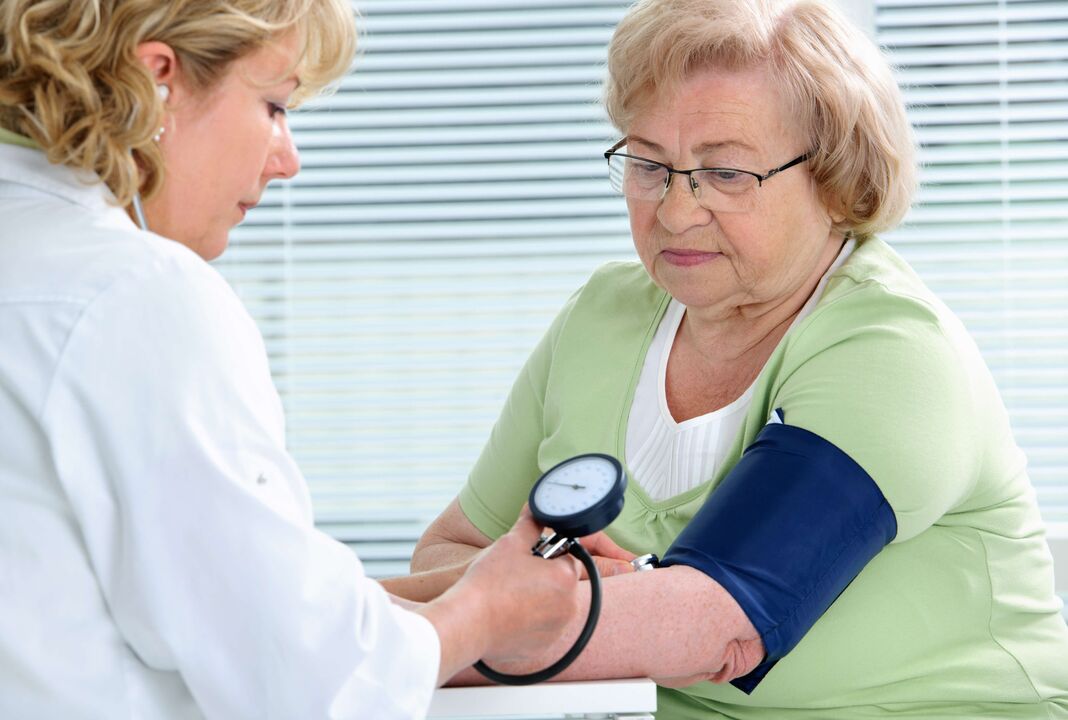 woman's blood pressure measured
